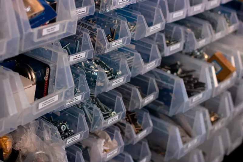 A wall of key blanks in bins